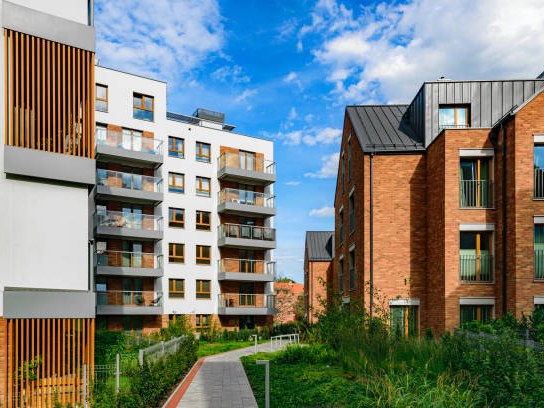Modern apartment buildings with balconies and landscaped walkway